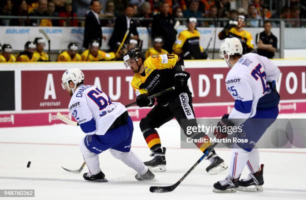 Marco Nowak of Germany and Florian Chakiachvili of France battle for the puck during the Icehockey International Friendly match between Germany and...