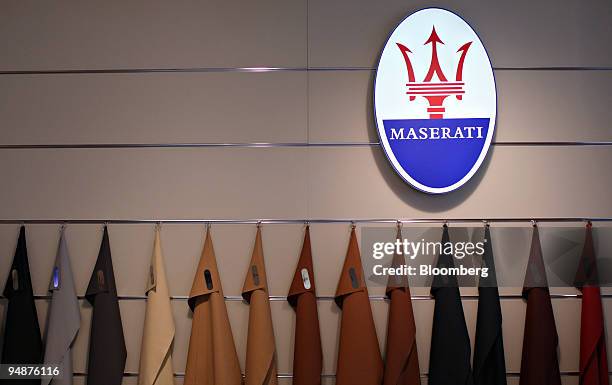 Leather samples hang below a Maserati logo in the Ferrari Maserati showroom in New York, U.S., on Tuesday, March 18, 2008. The GranTurismo S made its...