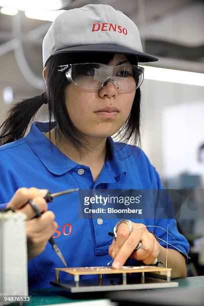 Trainee engineer Fuyuna Miyashita works on soldering and other precision techniques at Denso E & TS Training Center Corp. In Anjo City, Aichi...