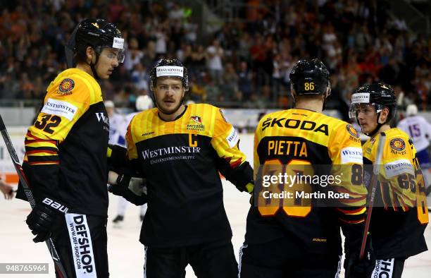 Oliver Mebus of Germany celebrate with his team mate after he scores the opening goal during the Icehockey International Friendly match between...