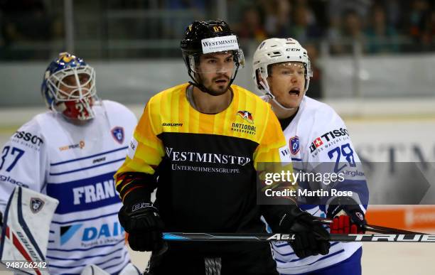 Mirko Hofflin of Germany Damien Raux of France battle for position in front of the net during the Icehockey International Friendly match between...