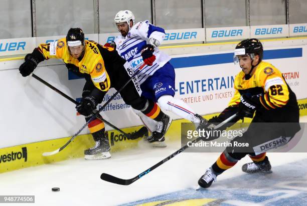 Bernhard Ebner of Germany and Damien Fleury of France battle for the puck during the Icehockey International Friendly match between Germany and...