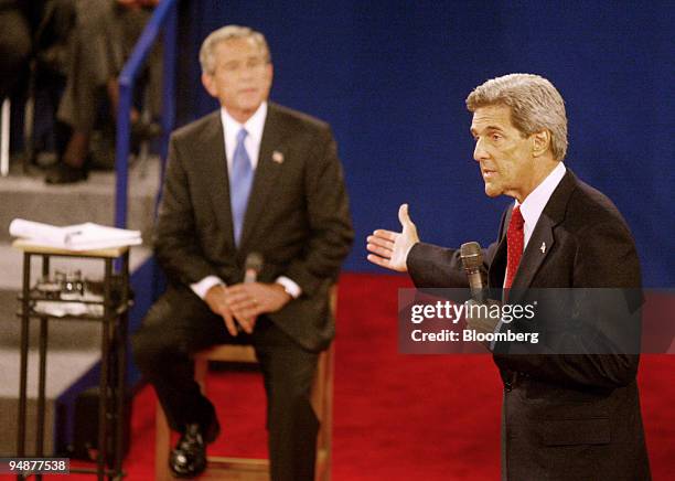 Democratic presidential nominee Senator John Kerry, right, gestures to U.S. President George W. Bush as he answers a question from an undecided voter...