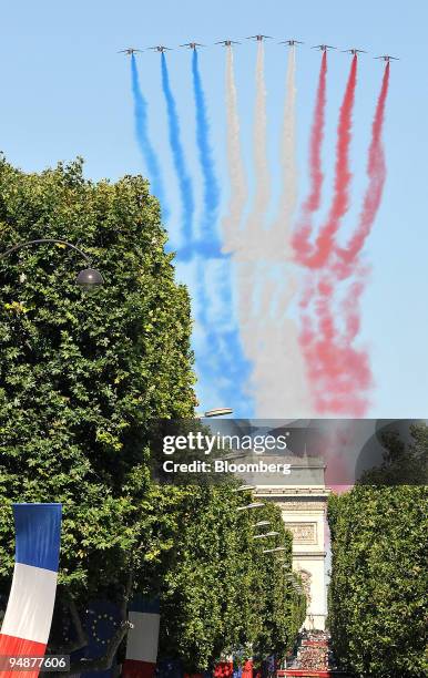 Military jets perform a flypast with the French national colours over the Champs Elysees during the Bastille Day celebrations in Paris, France, on...