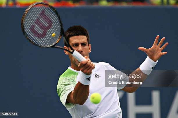 Novak Djokovic of Serbia returns to Roger Federer of Switzerland during their men's semifinal match on day 13 of the U.S. Open at the Billie Jean...