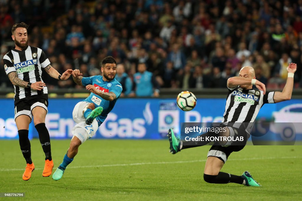 Napoli's Italian striker Lorenzo Insigne (C) kicks the ball...