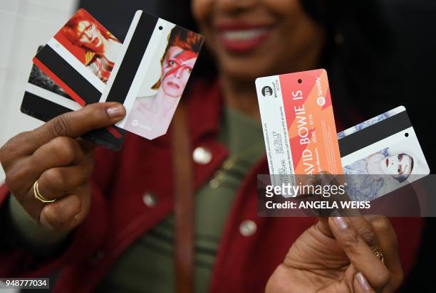 Woman holds up keepsake MetroCards available for purchase inside the Broadway-Lafayette station on April 19, 2018 in New York City, showing one of...