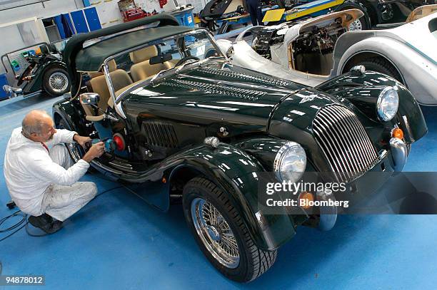 Worker polishes the bodywork of a Morgan Aero 8 car at the Morgan Motor Company Ltd in Malvern Link, Worcestershire, Thursday, October 7, 2004.
