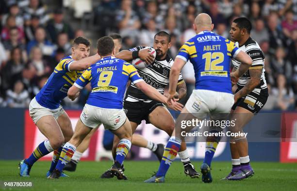 Sika Manu of Hull FC is tackled by Stevie Ward, Matt Parcell and Carl Ablett of Leeds during the BetFred Super League match between Hull FC and Leeds...