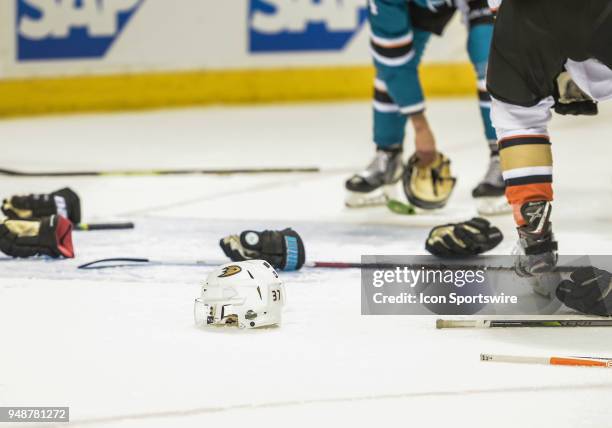 Gloves, helmets and sticks litter the ice after a scuffle during the Stanley Cup Playoff game between the Anaheim Ducks verses the San Jose Sharks on...