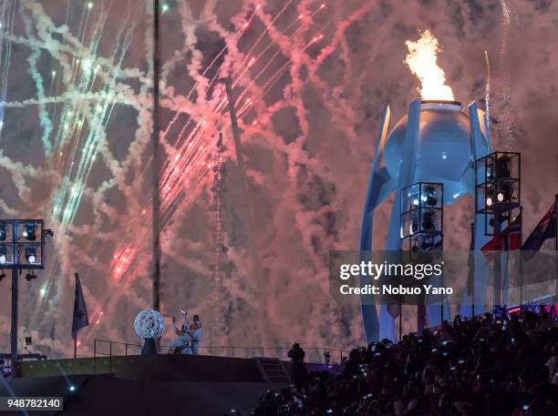 Seo Soonseok and Kim in silhouette with the Paralympic flame cauldron and fireworks during the opening ceremony of the PyeongChang 2018 Paralympic...