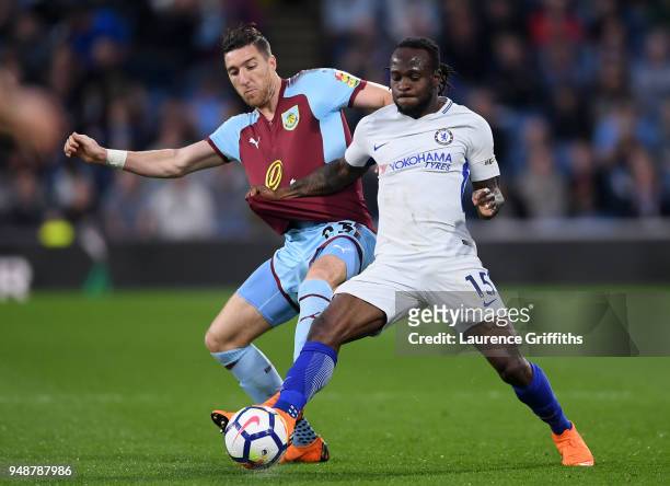 Victor Moses of Chelsea is challenged by Stephen Ward of Burnley during the Premier League match between Burnley and Chelsea at Turf Moor on April...