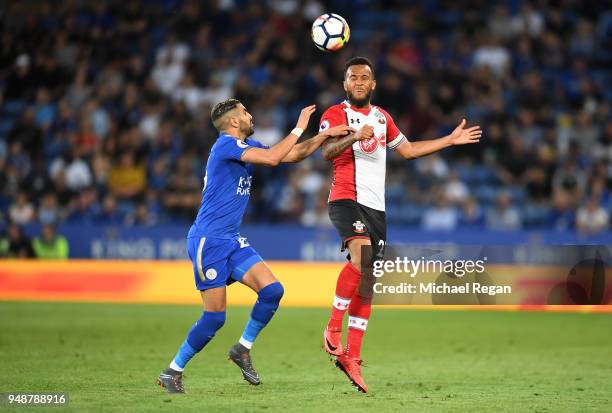 Ryan Bertrand of Southampton wins a header over Riyad Mahrez of Leicester City during the Premier League match between Leicester City and Southampton...