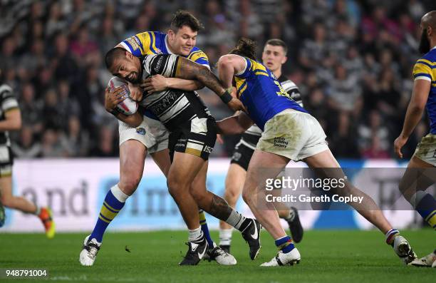 Sika Manu of Hull FC is tackled by Brett Ferres and Ashton Golding of Leeds during the BetFred Super League match between Hull FC and Leeds Rhinos at...