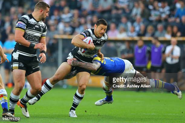 Mark Minichiello of Hull FC is tackled by Brett Delaney of Leeds Rhinos during the BetFred Super League match between Hull FC and Leeds Rhinos at the...