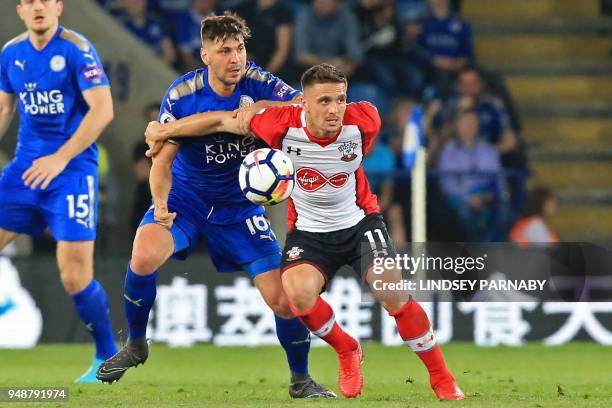 Southampton's Serbian midfielder Dusan Tadic vies with Leicester City's Austrian defender Aleksandar Dragovic during the English Premier League...