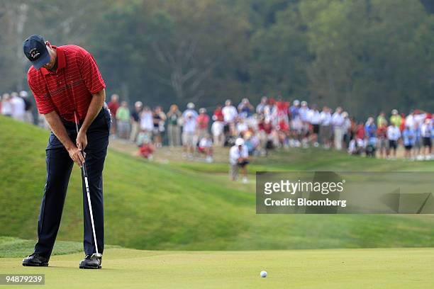 Stewart Cink of the U.S. Team hits a birdie putt on the 4th hole during a singles match against Graeme McDowell of the European team on day three of...