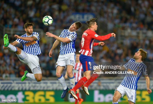 Atletico Madrid's forward Fernando Torres vies with Real Sociedad's Spanish defender Aritz Elustondo during the Spanish league football match Real...