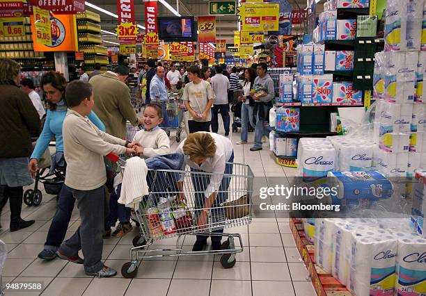 Family shops for groceries in a Carrefour supermarket in San Sebastian de los Reyes, Madrid, Spain, Saturday, October 29, 2005.