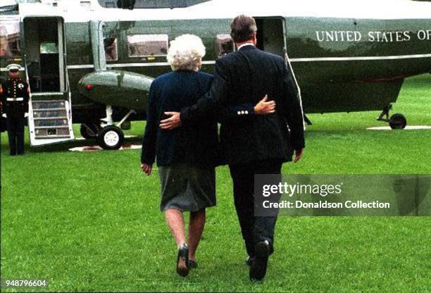 President George H.W. Bush and First Lady Barbara Bush walk arm in arm to Marine One in circa 1991.