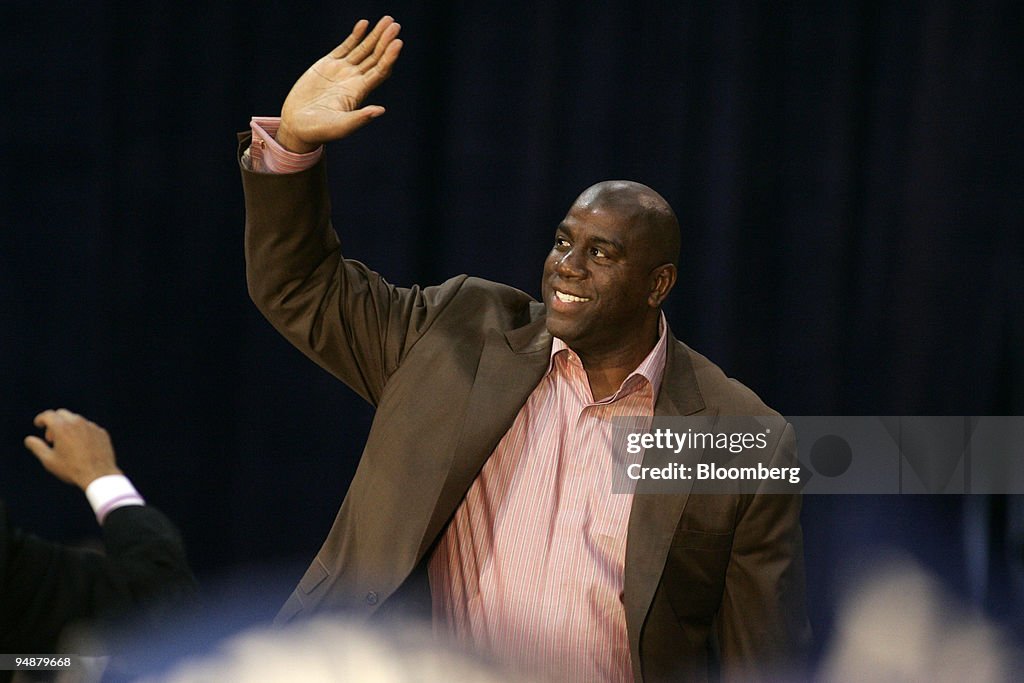 NBA great Earvin 'Magic' Johnson waves to the crowd at a cam