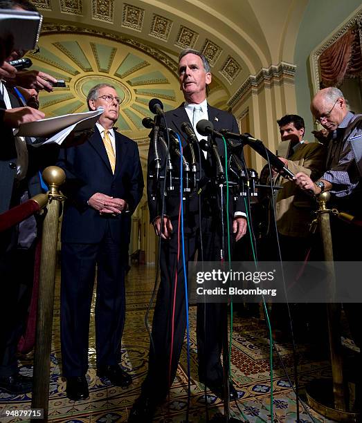 Mitch McConnell, a Republican senator from Kentucky, left, looks on as Judd Gregg, a Republican senator from New Hampshire, speaks during a news...