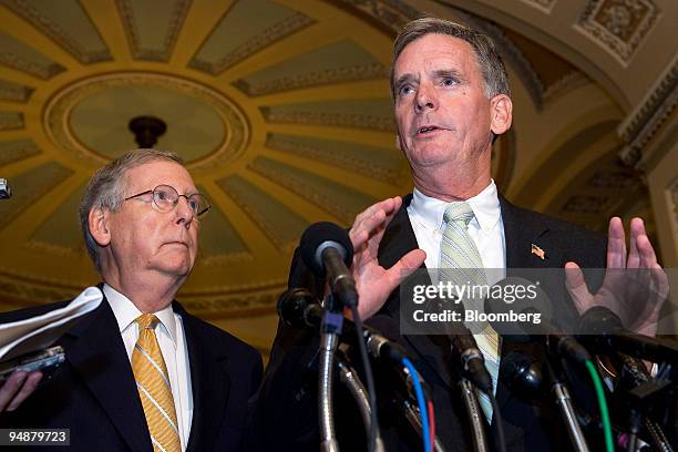 Mitch McConnell, a Republican senator from Kentucky, left, looks on as Judd Gregg, a Republican senator from New Hampshire, speaks during a news...