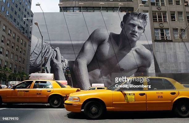 Cabs drive in front of a billboard surrounding the future home of a new Abercrombie & Fitch store, Thursday, June 2, 2005 in New York. Gasoline...