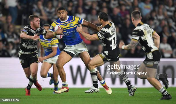 Kallum Watkins of Leeds is tackled Marc Sneyd and Mark Minichello of Hull FC during the BetFred Super League match between Hull FC and Leeds Rhinos...