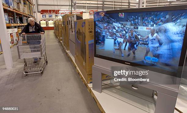 Customer walk past the televisions on display at the Costco Warehouse in Dedham, Massachusetts Thursday May 26, 2005. Costco Wholesale Corp., the...