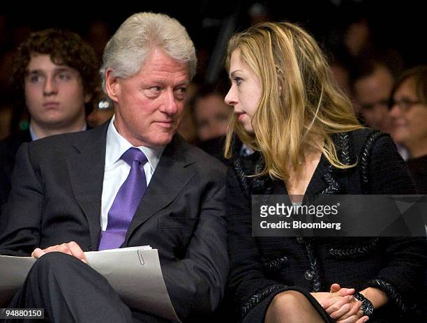 Former U.S. President Bill Clinton, left, chats with daughter Chelsea Clinton during the closing session of the Clinton Global Initiative annual...