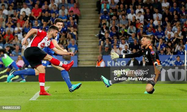 Shane Long of Southampton is denied by Leicester goalkeeper Ben Hamer during the Premier League match between Leicester City and Southampton at The...