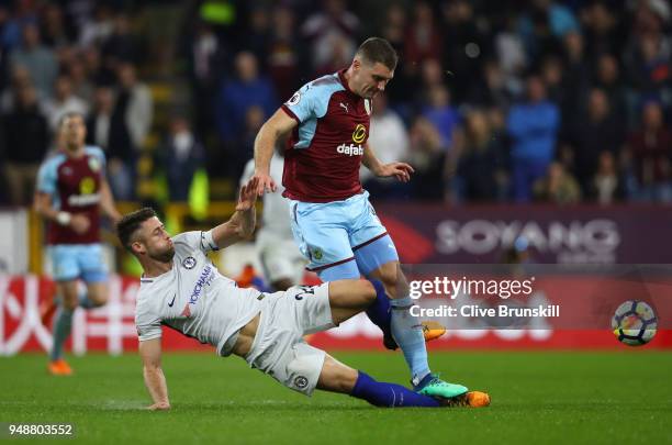 Gary Cahill of Chelsea tackles Sam Vokes of Burnley during the Premier League match between Burnley and Chelsea at Turf Moor on April 19, 2018 in...