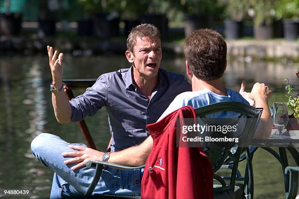 Investor Vivi Nevo, left, talks with Edgar Bronfman, chairman and chief executive officer with Warner Music Group Corp., during a lunch break...