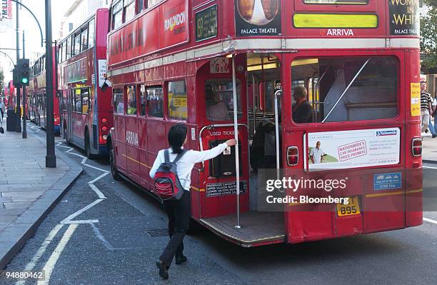 Passenger boards a London Routemaster bus in central London, Saturday, September 24, 2005. The archetypal London bus is the Routemaster. An open...