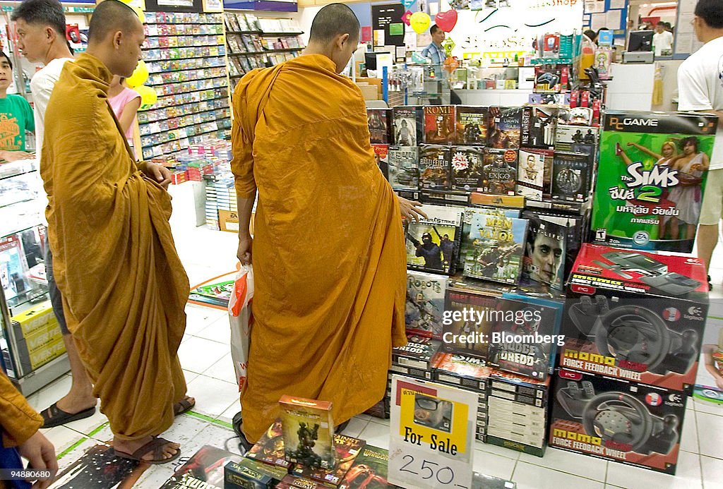 Two Thai monks check out the latest computer games on sale M