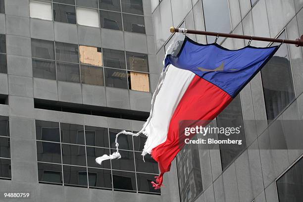 Battered Texas flag hangs from the JPMorgan Chase & Co. Tower in downtown Houston, Texas, September 24, 2005. The Tower and Chase Center across the...