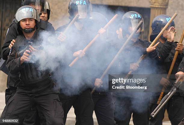 Police use tear gas to repel demonstrators at the entrance of the Finance Ministry where International Monetary Fund Director Rodrigo de Rato was...