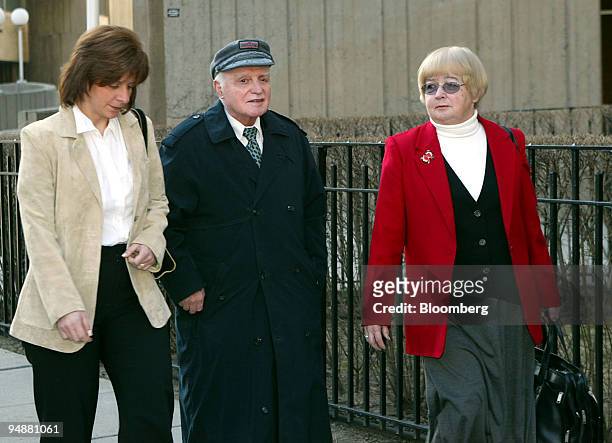 John Rigas, founder and former chairman, Adelphia Communications Corp., center, walks with his friend, Shirlee Leete, right, and another unidentified...