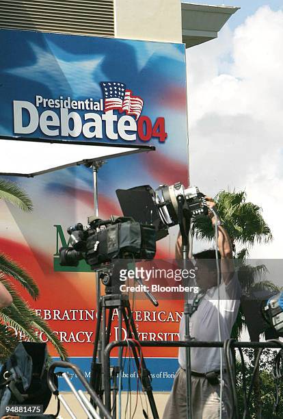 Television cameraman adjusts a light outside of the Convocation Center at the University of Miami in Coral Gables, Florida on September 29, 2004...