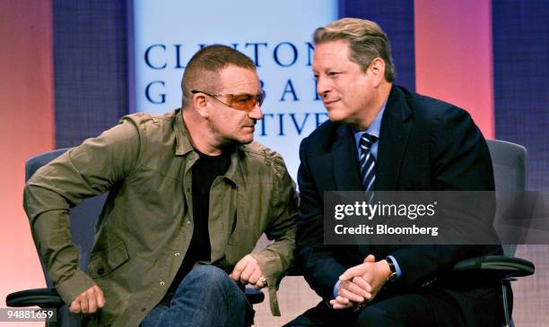 Bono and Al Gore, former U.S. Vice president, participate in the opening plenary on day one of the Clinton Global Initiative in New York, U.S., on...