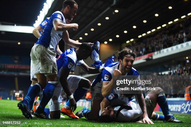 Charlie Mulgrew of Blackburn Rovers celebrates with Bradley Dack after he scores the third goal during the Sky Bet League One match between Blackburn...