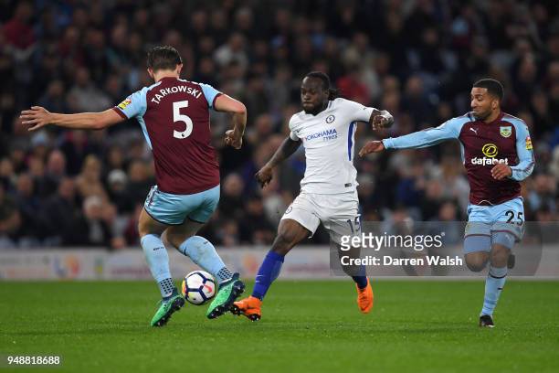 Victor Moses of Chelsea runs with the ball under pressure from James Tarkowski of Burnley and Aaron Lennon of Burnley during the Premier League match...