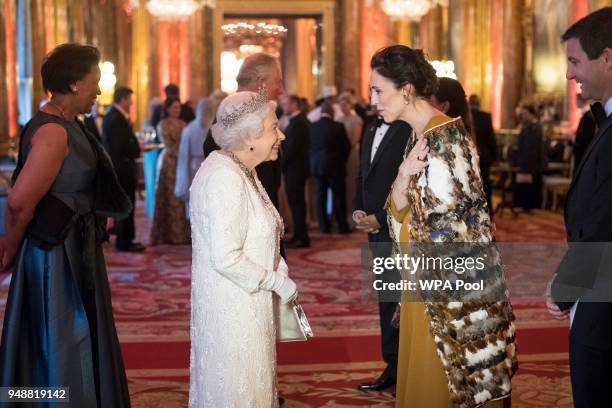 Queen Elizabeth II greets Jacinda Ardern, Prime Minister of New Zealand in the Blue Drawing Room at The Queen's Dinner during the Commonwealth Heads...