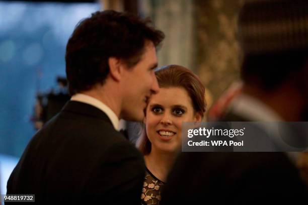 Britain's Princess Beatrice and her father Prince Andrew, obscured, talk with Canadian Prime Minister Justin Trudeau during a reception for the...