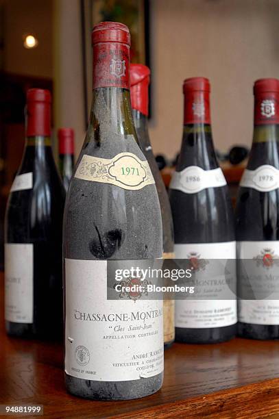 Bottles of Chassagne-Montrachet Clos Saint Jean sit on a table at the los Saint Jean vineyard, in the Burgundy village of Chassagne-Montrachet,...