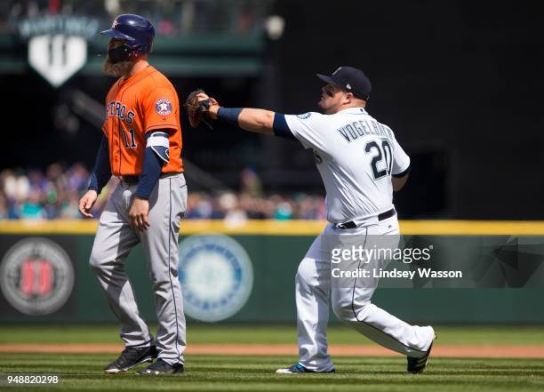 Daniel Vogelbach of the Seattle Mariners tags Evan Gattis of the Houston Astros out for a triple play as Gattis walks off the field thinking there...