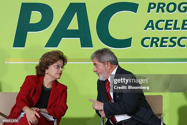 Luiz Inacio Lula da Silva, Brazil's president, right, speaks to Dilma Roussef, Brazil's chief of staff, during a ceremony after the signature of the...