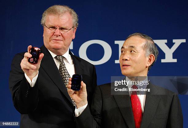 Sony Corp. President Ryoji Chubachi, right, and chief executive Howard Stringer hold up Walkman Connect MP3 players during a press briefing in Tokyo...