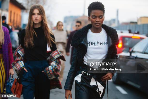 Haitian model Aube Jolicoeur wears a black leather jacket and "MELANIN" t-shirt in the Friends font, and a black leather skirt during Milan Fashion...
